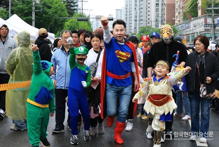슈퍼맨으로 변신한 오언석 도봉구청장이 아이들과 함께 캐릭터 퍼레이드를 선보이고 있다